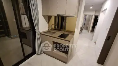 Modern kitchen with sleek cabinetry and induction cooktop in a stylish apartment