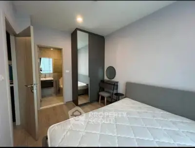 Modern bedroom with ensuite bathroom and stylish furniture in a contemporary apartment.