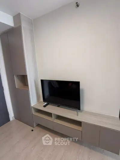 Modern living room with sleek TV unit and storage cabinets