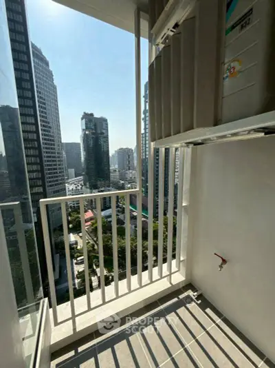 Modern high-rise balcony with stunning cityscape view and ample sunlight.