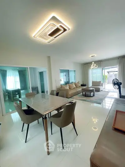 Spacious modern living room with elegant dining area and stylish lighting