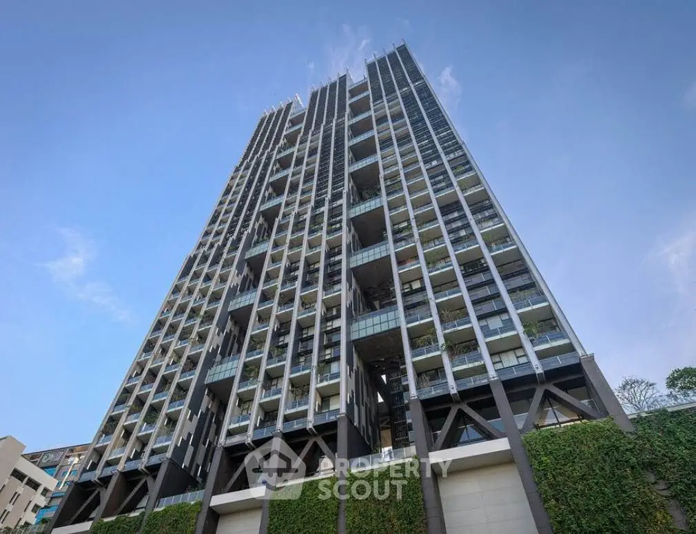 Stunning modern high-rise building with lush greenery and spacious balconies.