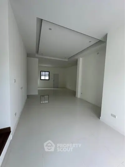 Spacious modern interior with high ceilings and sleek white flooring