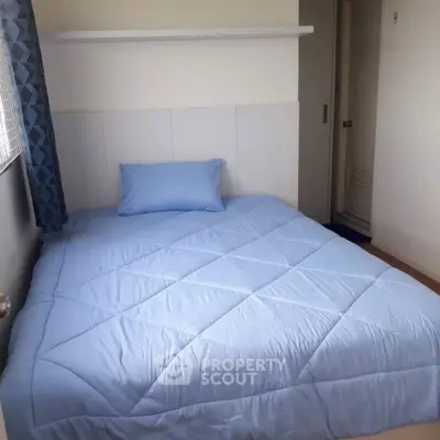 Cozy bedroom with blue bedding and modern decor