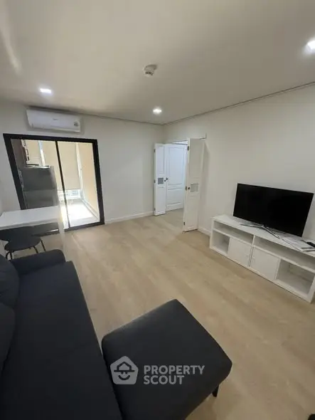 Modern living room with sleek furniture and natural light, perfect for relaxation and entertainment.