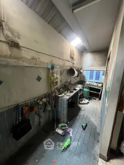 Rustic kitchen with open layout and vintage charm, featuring exposed brick and eclectic decor.