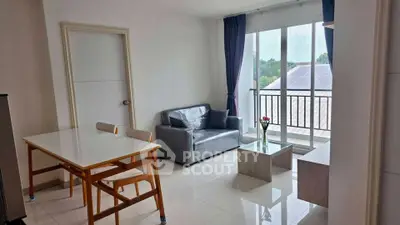 Bright living room with modern furniture and large windows offering natural light.
