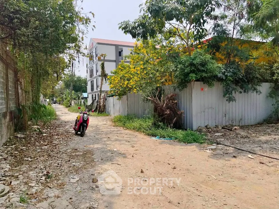 Explore potential real estate development on this spacious plot with lush greenery and urban proximity.