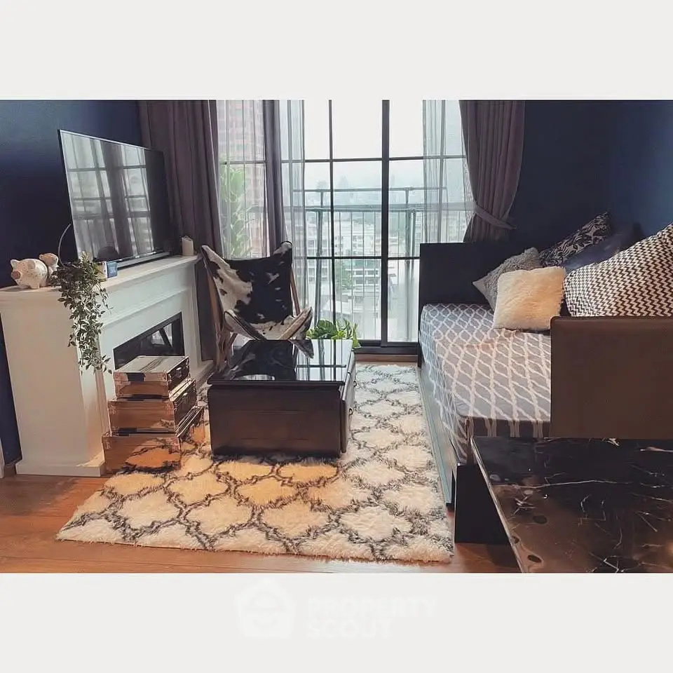 Chic living room with modern decor, large window, and cozy seating area.