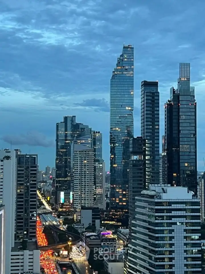Stunning cityscape view of modern skyscrapers at dusk with vibrant city lights.