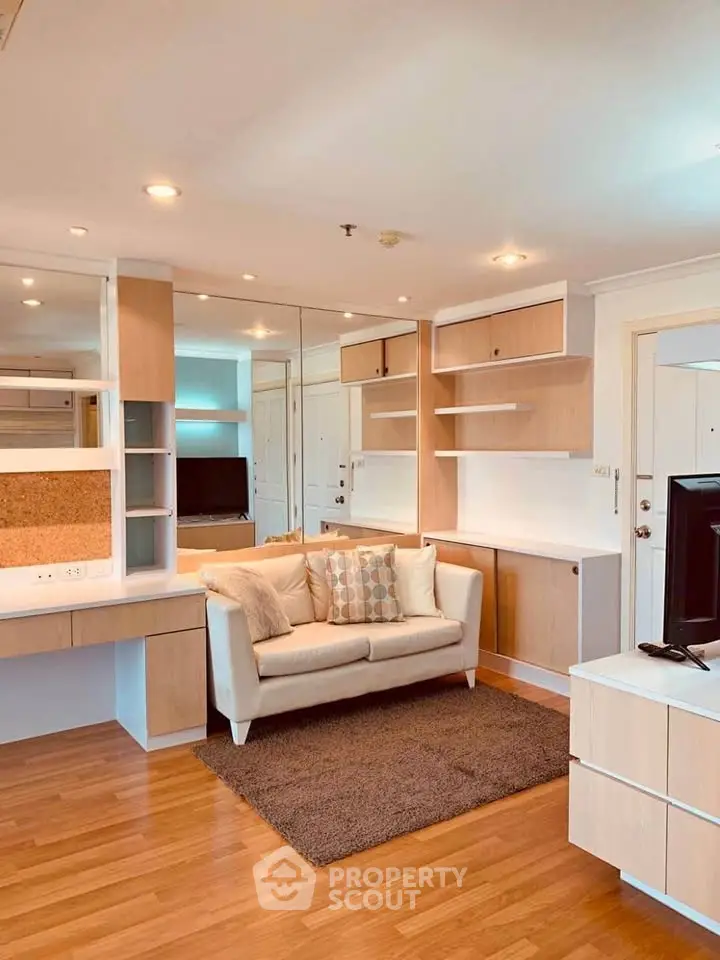 Modern living room with stylish built-in shelves and cozy sofa in a bright apartment.