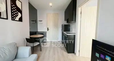 Modern compact apartment with sleek kitchen and cozy living area.