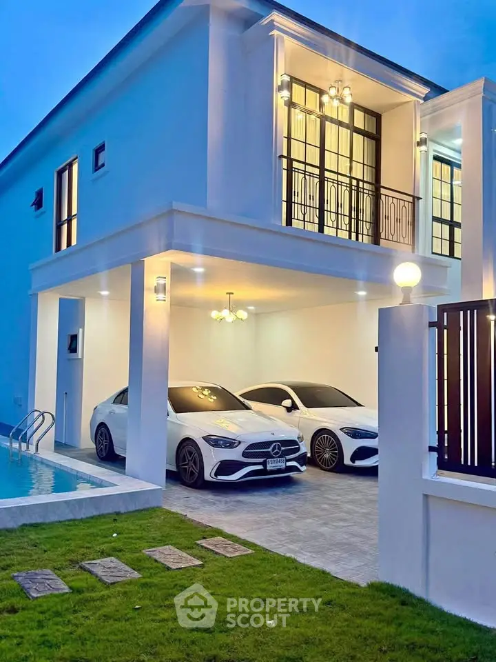Luxurious modern home with pool and double garage at dusk