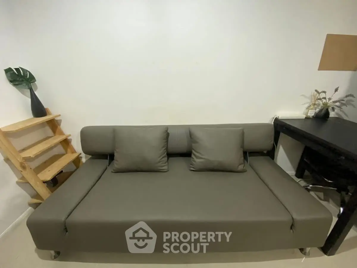 Modern minimalist living room with sleek gray sofa and stylish decor