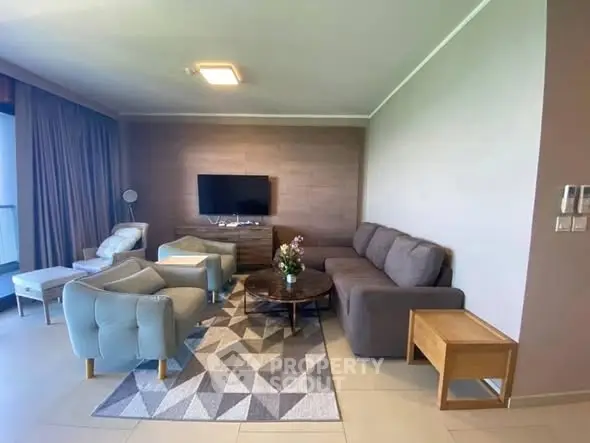 Spacious modern living room with stylish furniture and wall-mounted TV