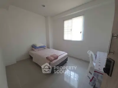 Cozy minimalist bedroom with single bed and natural light