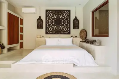 Luxurious bedroom with elegant decor and modern design, featuring a stylish bed and artistic wall panel.