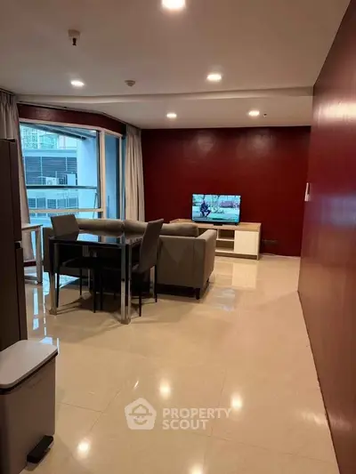 Spacious modern living room with elegant furniture and large windows offering natural light.