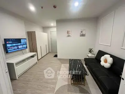Modern living room with sleek furniture and wall-mounted TV, perfect for cozy relaxation.