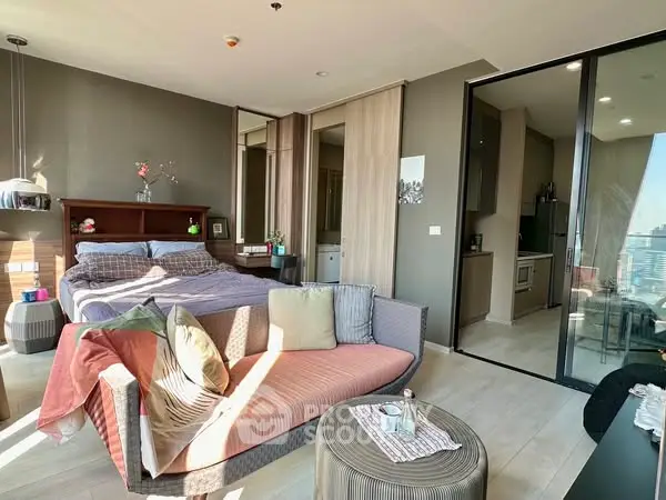 Modern studio apartment with cozy living area and city view balcony