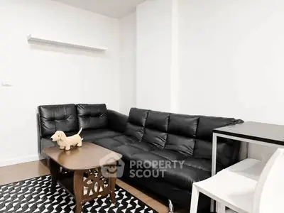 Modern living room with black leather sofa and stylish decor