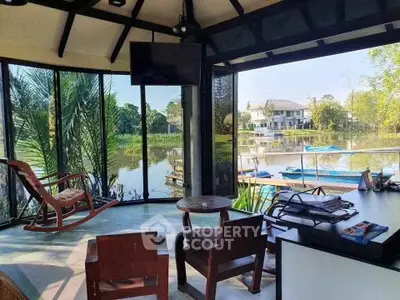 Stunning waterfront living room with panoramic views and cozy seating area.