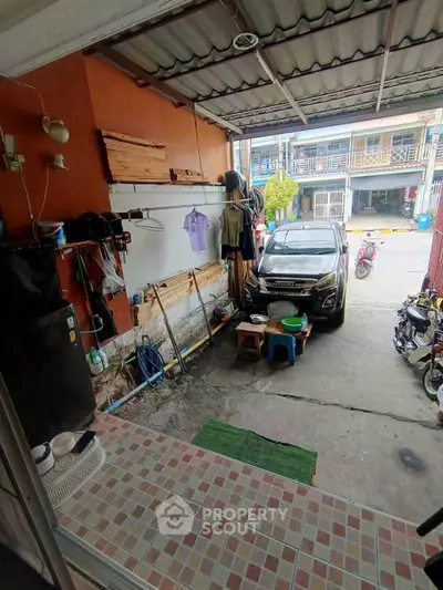 Cozy garage space with tiled flooring and ample storage, perfect for urban living.