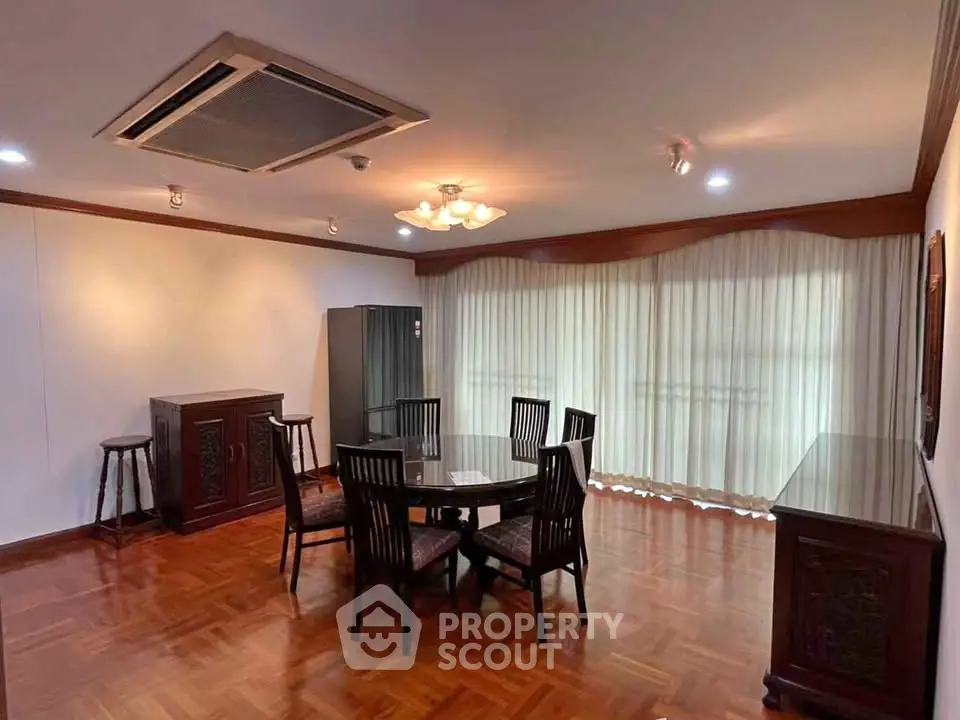 Spacious dining area with elegant wooden flooring and modern furniture