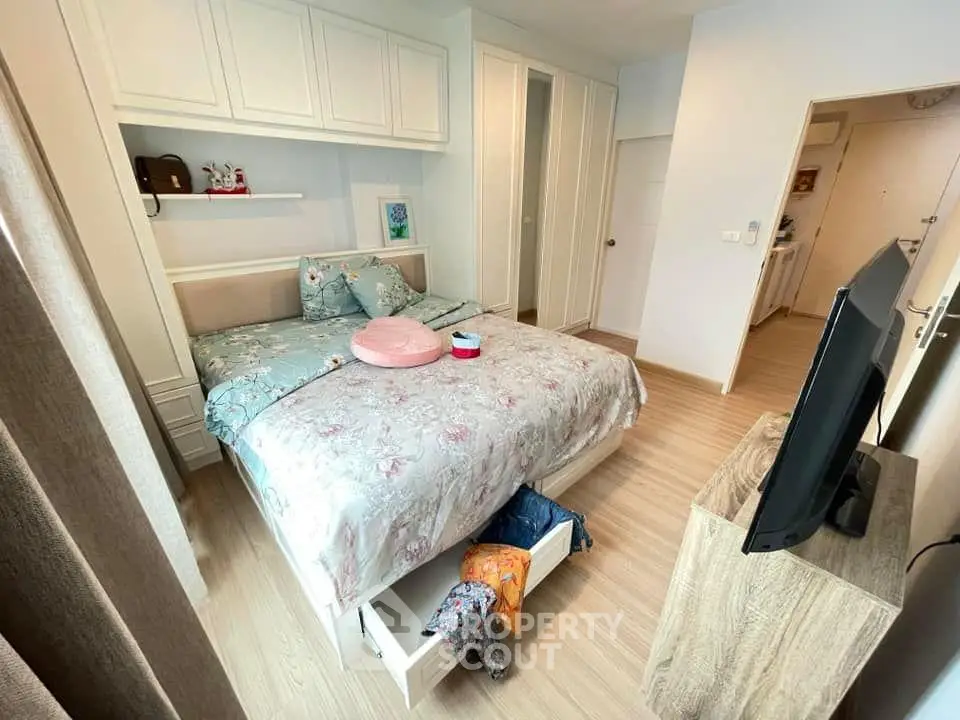 Cozy bedroom with stylish decor and ample storage in modern apartment