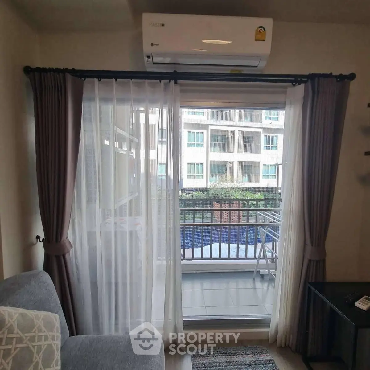 Cozy living room with balcony view in modern apartment