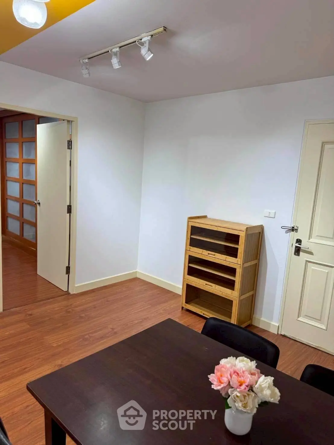 Charming dining area with wooden flooring and elegant decor, perfect for cozy gatherings.