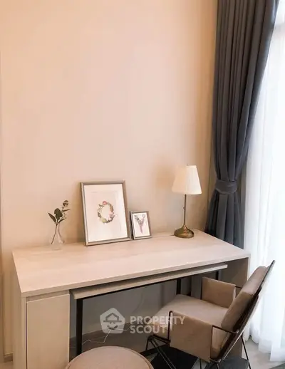 Elegant study area with modern desk, stylish chair, and decorative accents in a bright room.