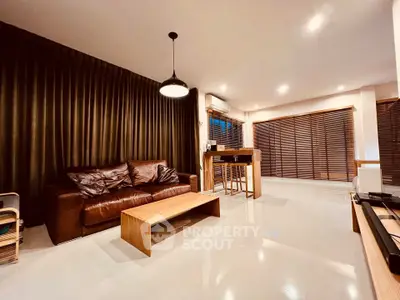 Spacious modern living room with leather sofa and stylish lighting