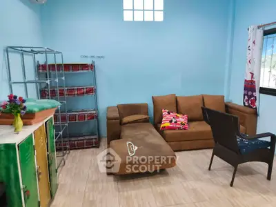 Cozy living room with brown sofa, colorful cushions, and modern decor