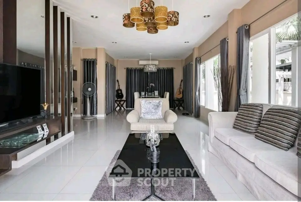 Spacious modern living room with elegant decor and ample natural light.