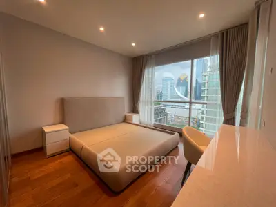 Modern bedroom with city view, featuring sleek design and large windows for natural light.