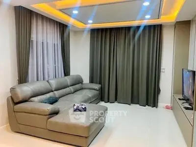 Modern living room with stylish ceiling lights and comfortable leather sofa.