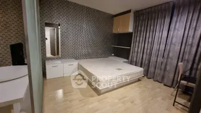 Spacious bedroom with modern decor and large window curtains, featuring a comfortable bed and stylish wallpaper.