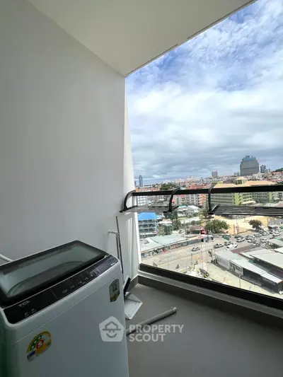 Modern balcony with city view and washing machine, perfect for urban living.