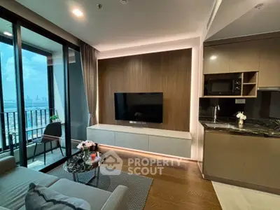 Modern living room with balcony view and sleek kitchen design in luxury apartment.