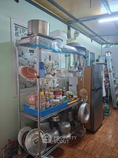 Spacious kitchen with stainless steel shelving and modern appliances, perfect for culinary enthusiasts.