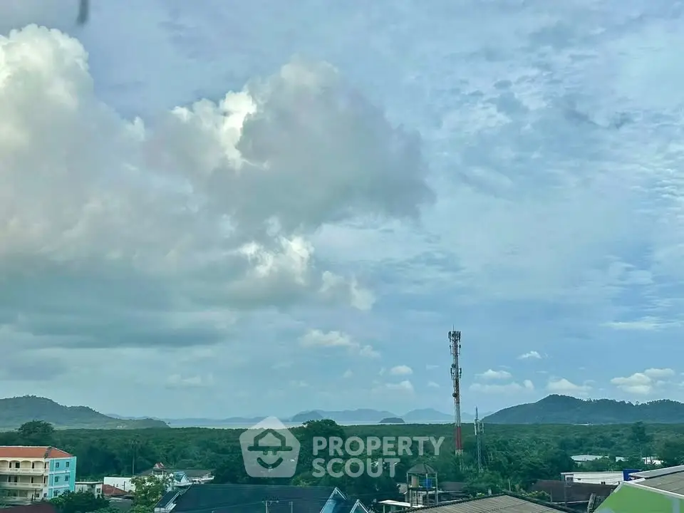 Scenic view of lush green landscape with mountains and cloudy sky, ideal for serene living.