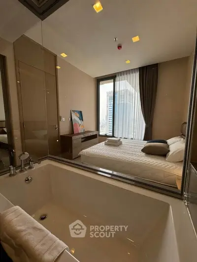 Luxurious bedroom with ensuite bathtub and city view, perfect for urban living.