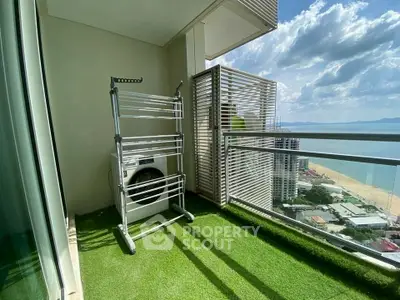 Stunning high-rise balcony with ocean view and artificial grass flooring.