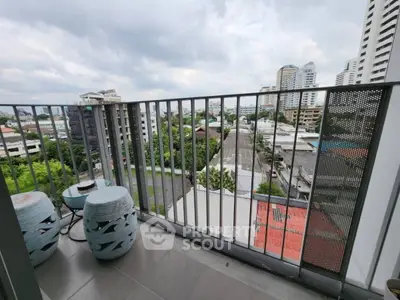 Spacious balcony with city view in modern apartment building