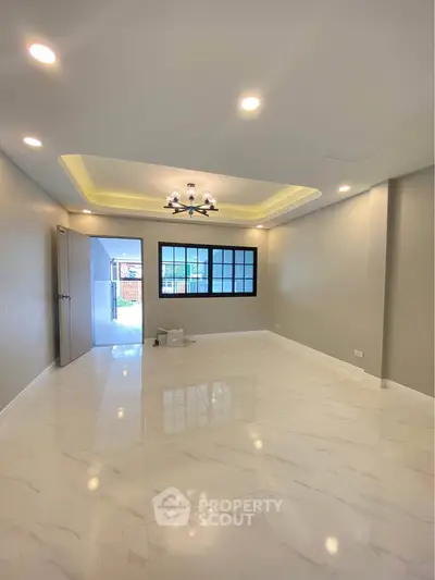 Spacious modern living room with elegant lighting and glossy flooring