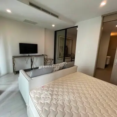 Modern studio apartment with open layout, featuring a cozy living area and stylish furnishings.