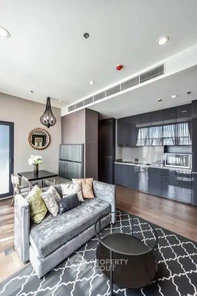 Modern living room with sleek kitchen and stylish decor