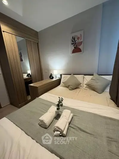 Cozy modern bedroom with stylish decor and ample natural light