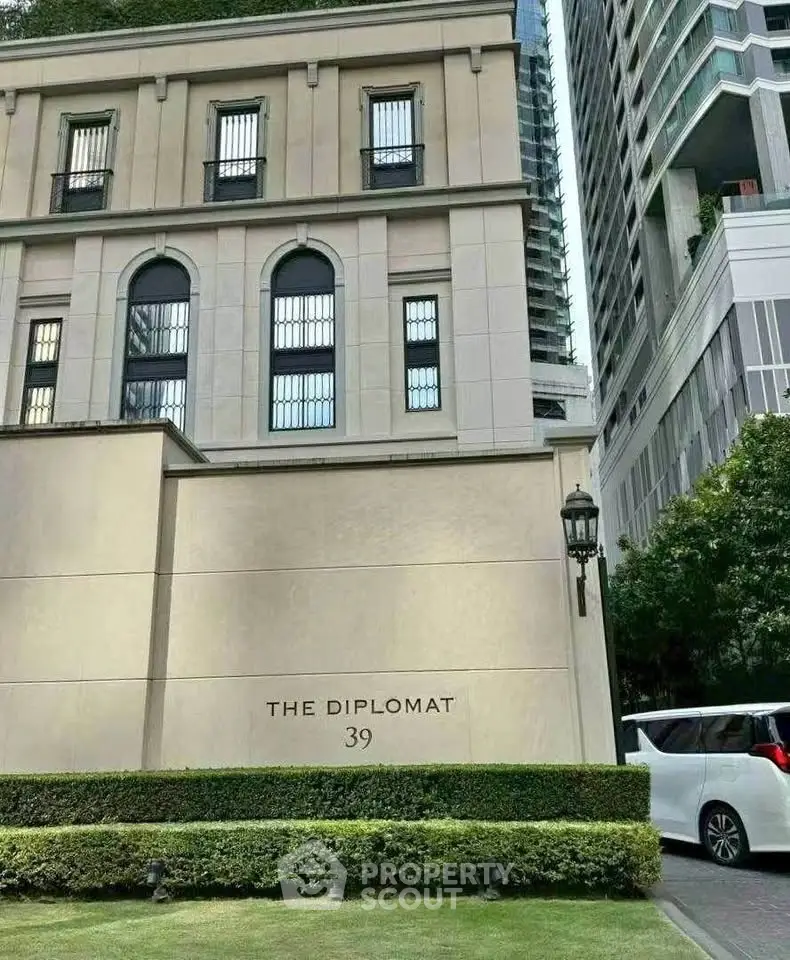 Elegant facade of The Diplomat 39 with lush greenery and modern architecture.